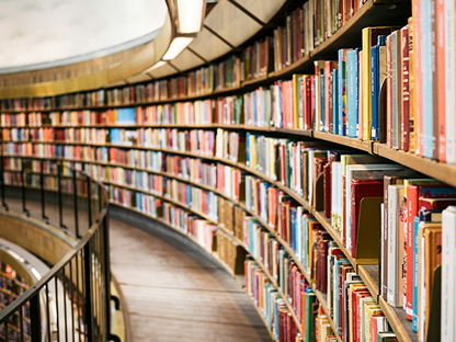 Curved shelves filled with books in a library