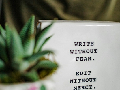 Framed writing quote beside a plant